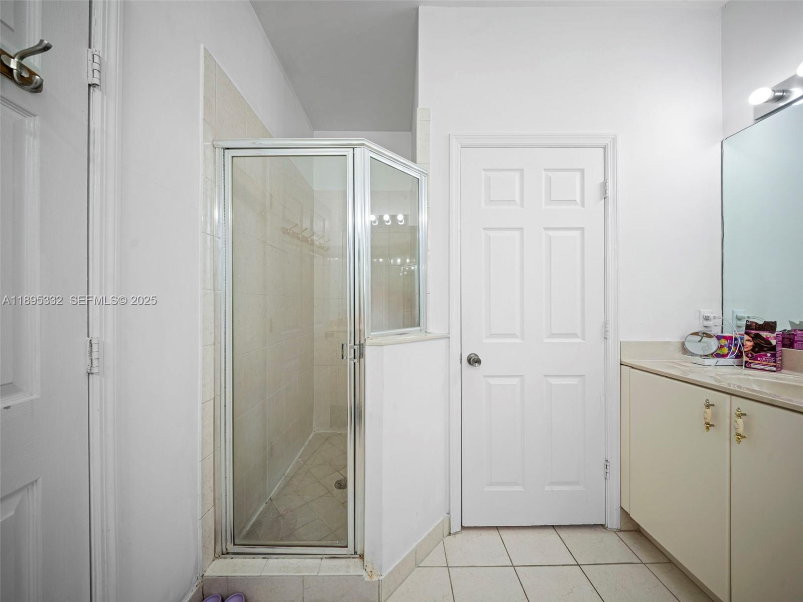 2104 Northeast 3rd Court Homestead, FL 33033 - Photo 22 of 35 a bathroom with a shower and a sink