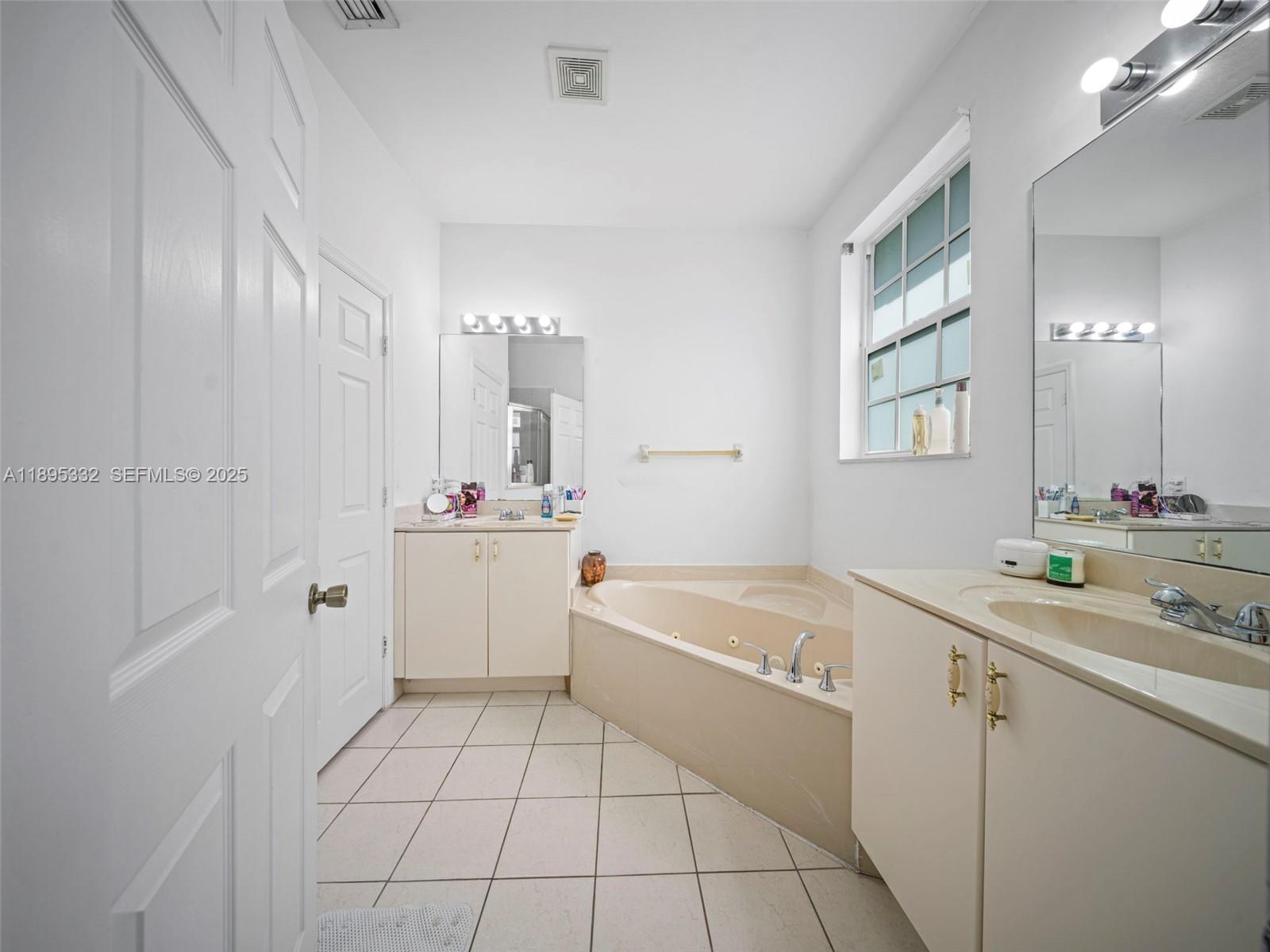 2104 Northeast 3rd Court Homestead, FL 33033 - Photo 23 of 35 a bathroom with a sink a tub and mirror