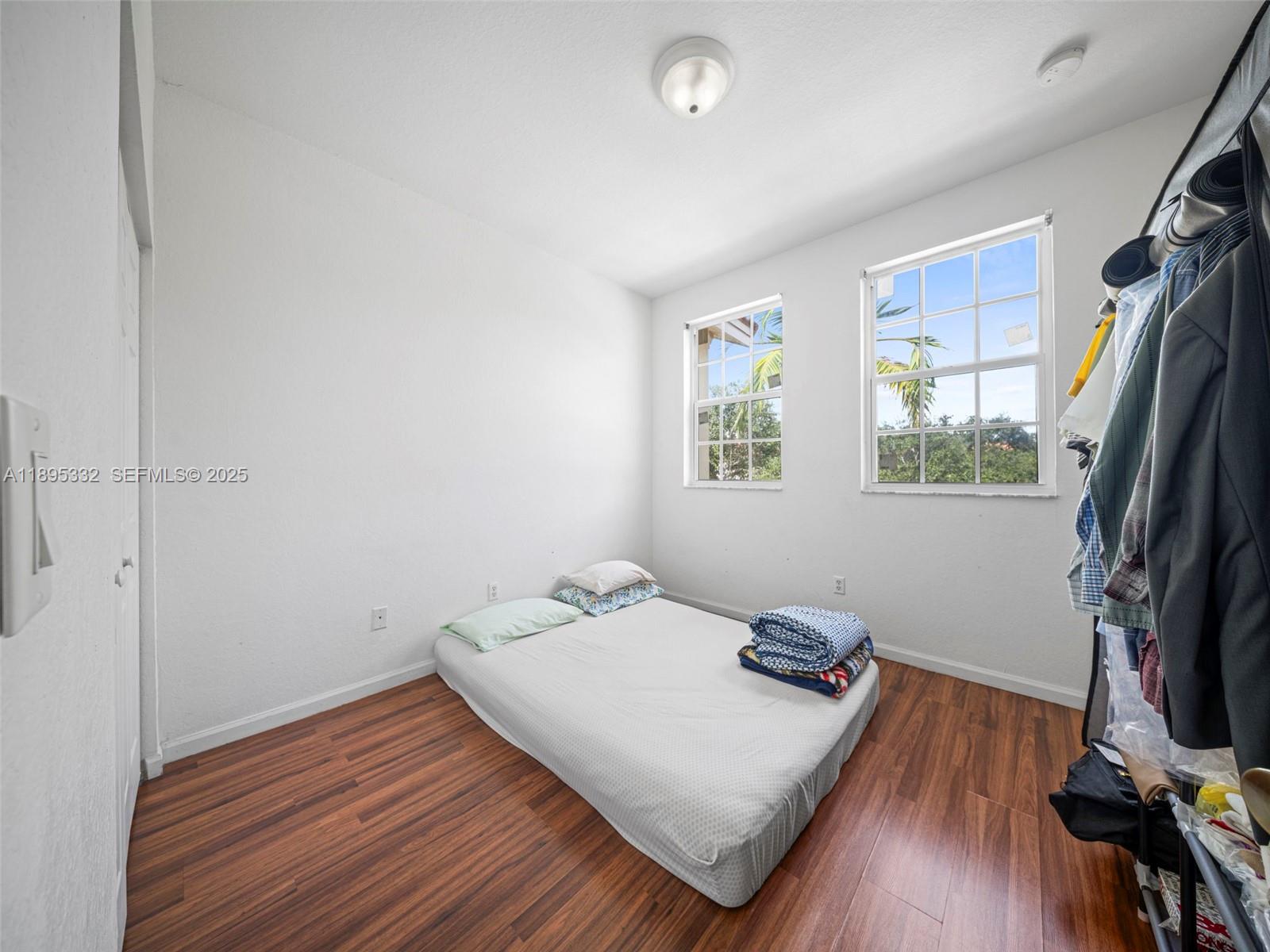 2104 Northeast 3rd Court Homestead, FL 33033 - Photo 24 of 35 a bedroom with a bed and a flat screen tv