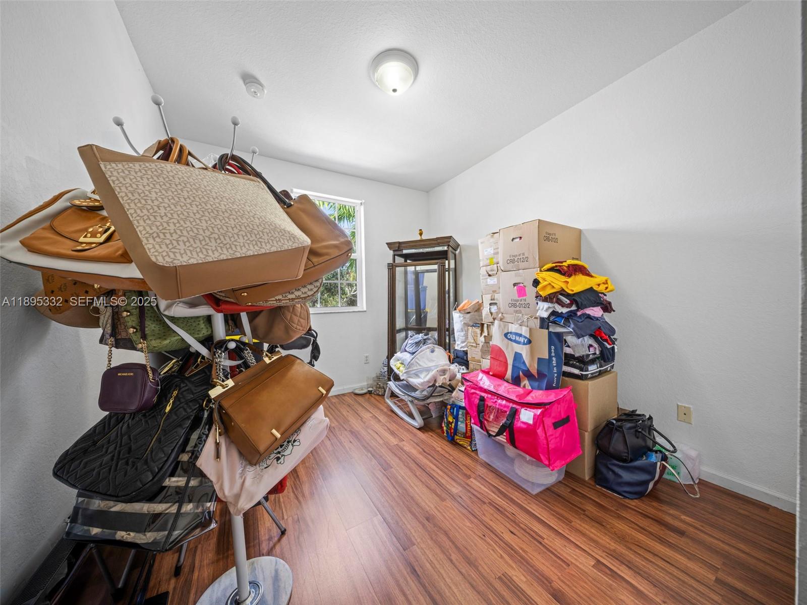 2104 Northeast 3rd Court Homestead, FL 33033 - Photo 25 of 35 a bedroom with furniture and a wooden floor