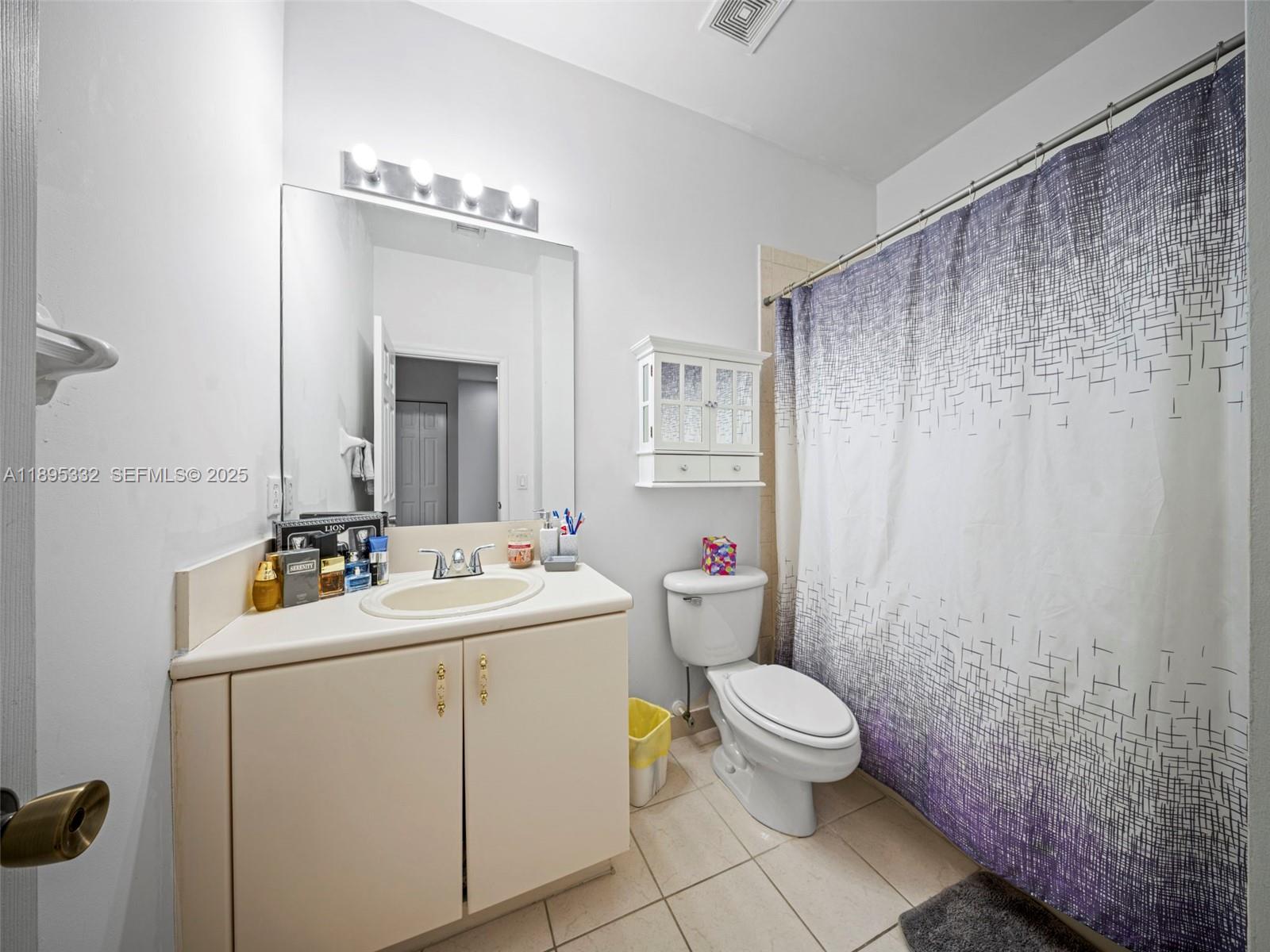 2104 Northeast 3rd Court Homestead, FL 33033 - Photo 26 of 35 a bathroom with a sink a toilet and mirror