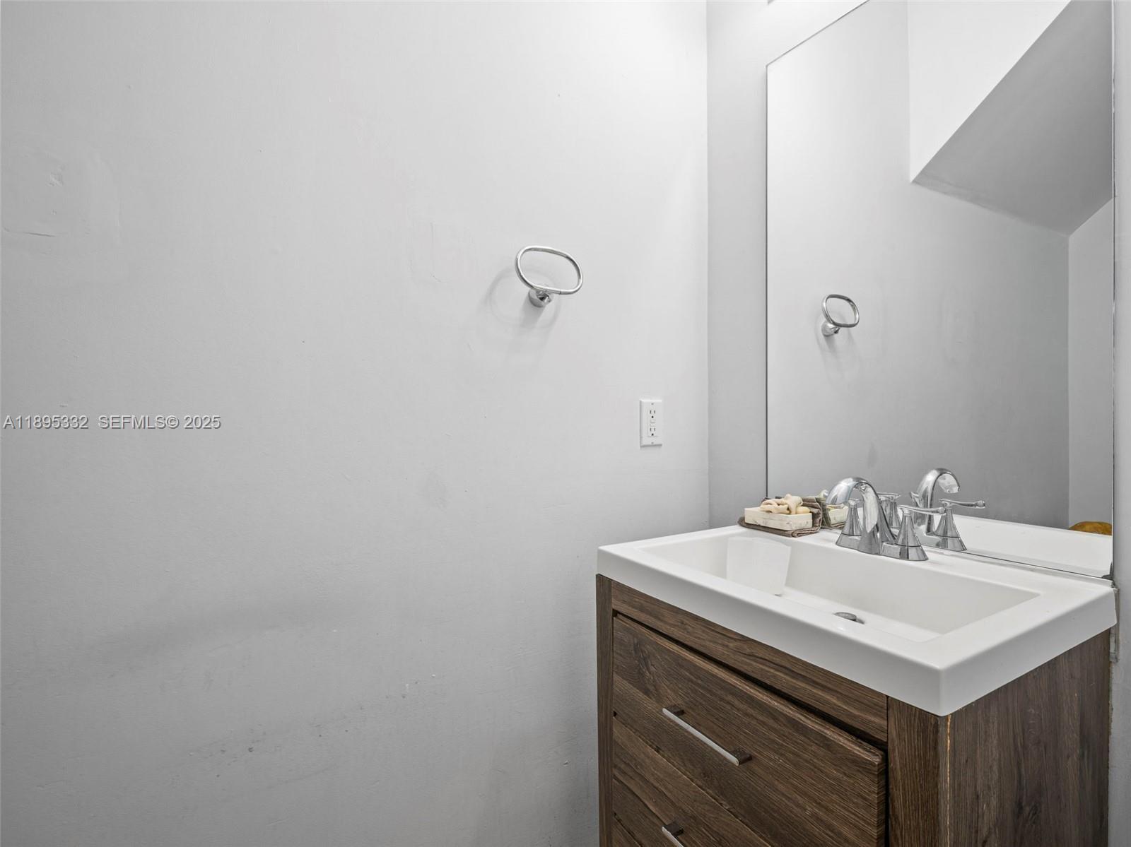 2104 Northeast 3rd Court Homestead, FL 33033 - Photo 27 of 35 a bathroom with a sink and a mirror