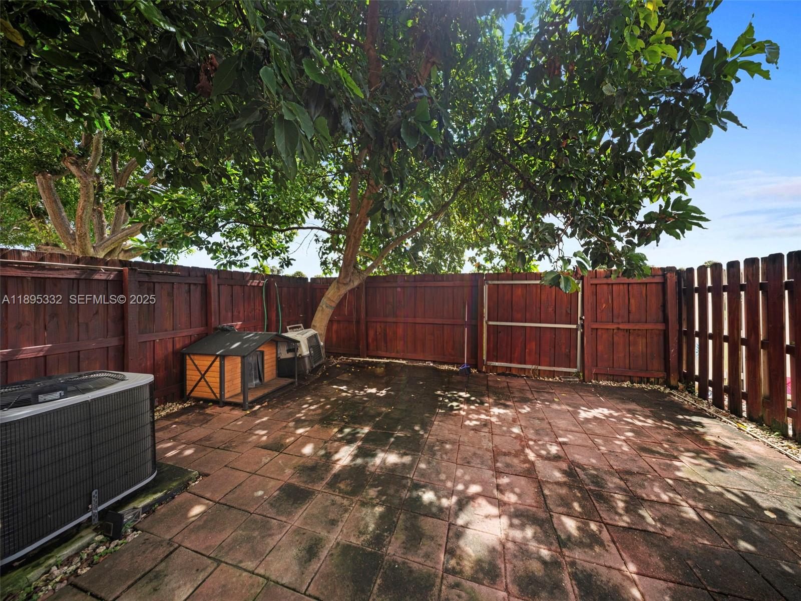 2104 Northeast 3rd Court Homestead, FL 33033 - Photo 30 of 35 a view of a backyard with a barbeque and large trees