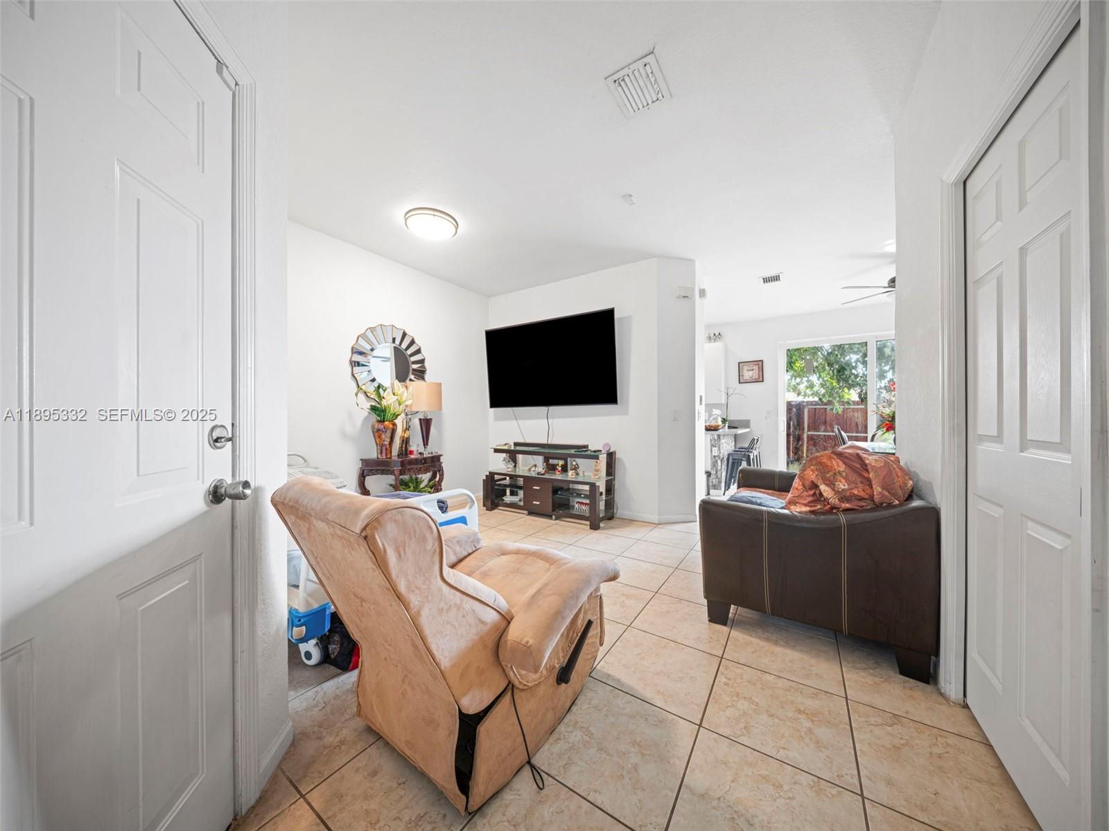 2104 Northeast 3rd Court Homestead, FL 33033 - Photo 10 of 35 a living room with furniture and a flat screen tv