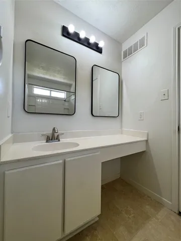 a bathroom with 2 sink and a mirror
