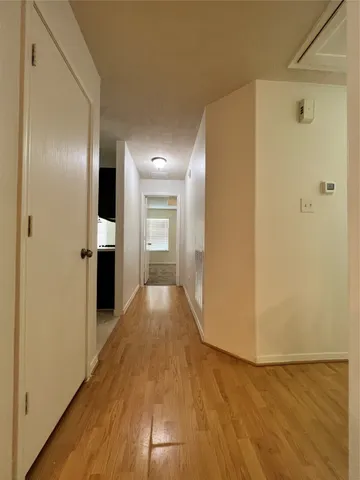 a view of hallway with wooden floor