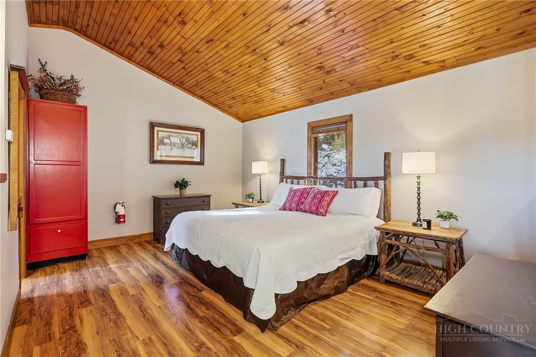 140 Lindale Ridge, Unit 504 Boone, NC 28607 - Photo 7 of 15 a bedroom with a bed and wooden floor