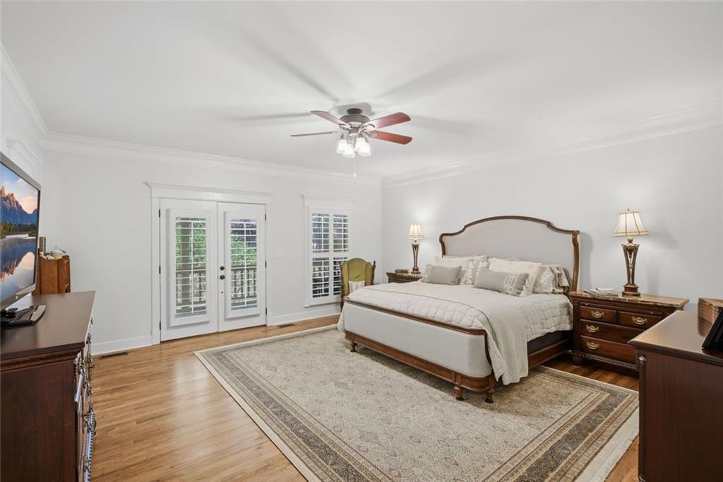 1852 Oak Grove Road Dahlonega, GA 30533 - Photo 39 of 68 a bedroom with a large bed and a chandelier