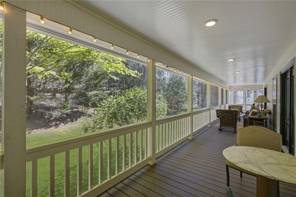 1852 Oak Grove Road Dahlonega, GA 30533 - Photo 48 of 68 a view of a porch with chairs and wooden floor
