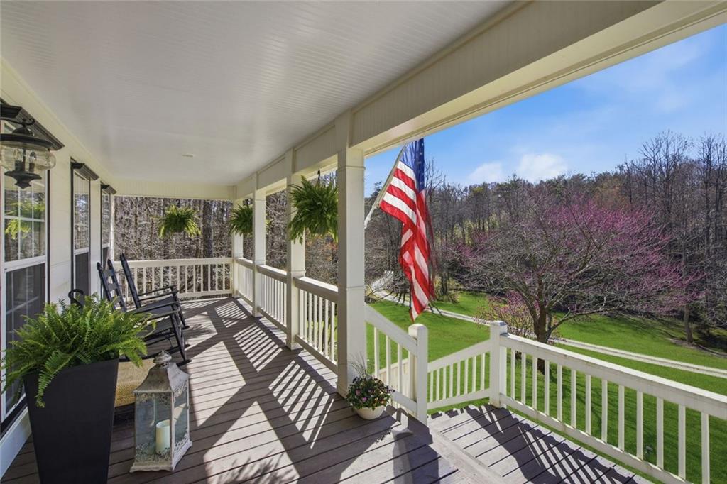 1852 Oak Grove Road Dahlonega, GA 30533 - Photo 6 of 68 a view of a balcony with wooden floor and fence