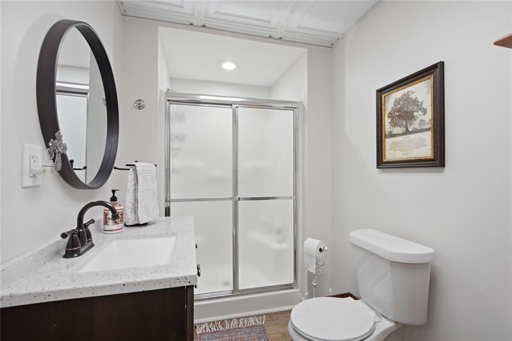 1852 Oak Grove Road Dahlonega, GA 30533 - Photo 66 of 68 a bathroom with a sink toilet and a mirror