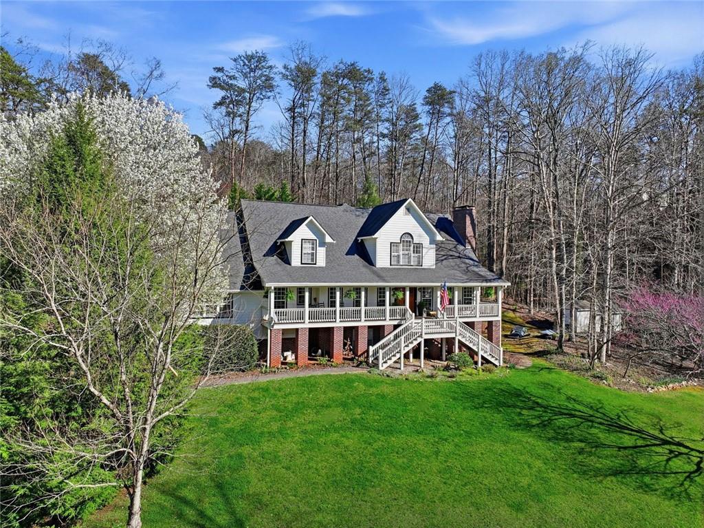 1852 Oak Grove Road Dahlonega, GA 30533 - Photo 9 of 68 a view of a wooden house with a yard