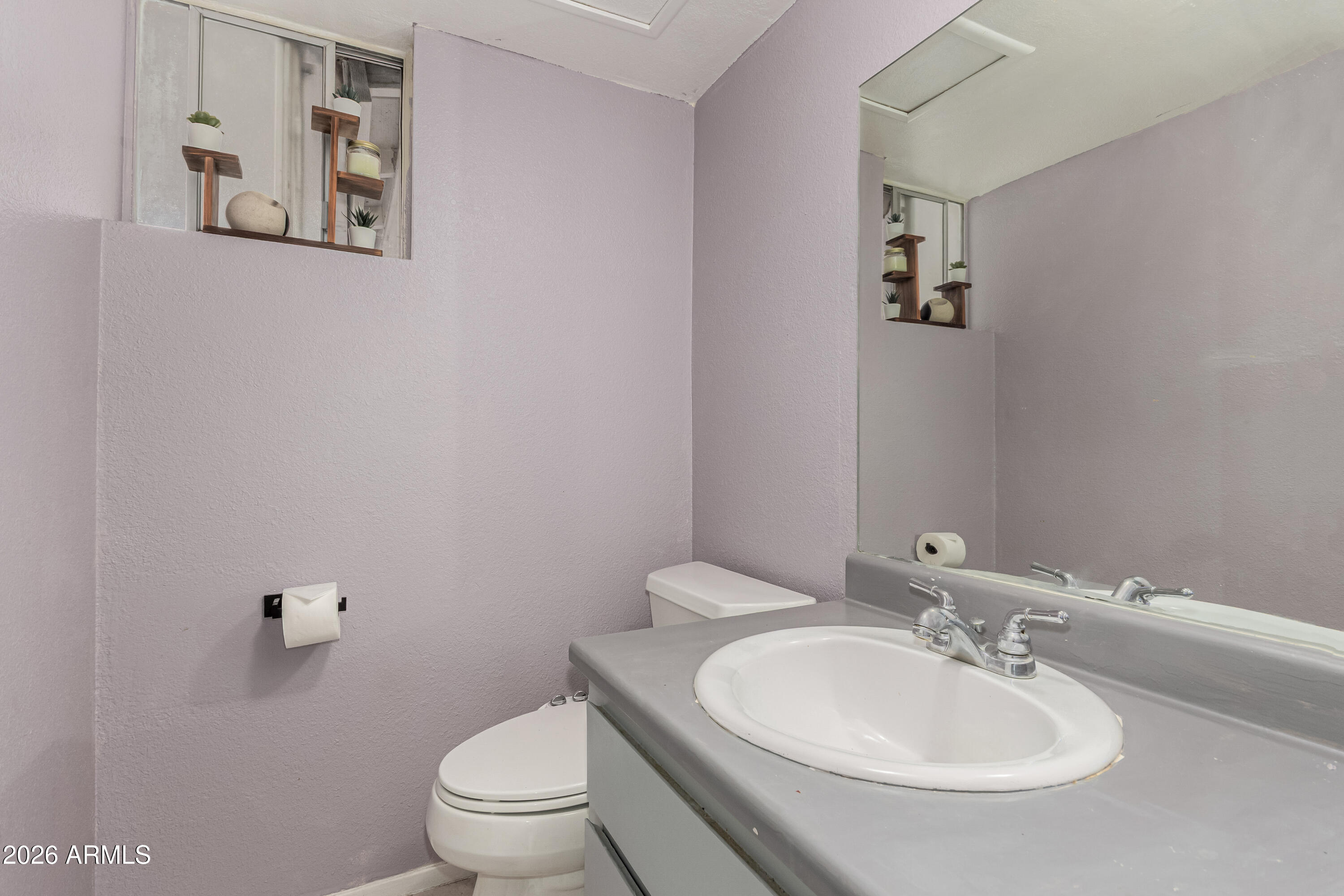 1531 West Colter Street, Unit 1 Phoenix, AZ 85015 - Photo 14 of 32 a bathroom with a toilet a sink and mirror