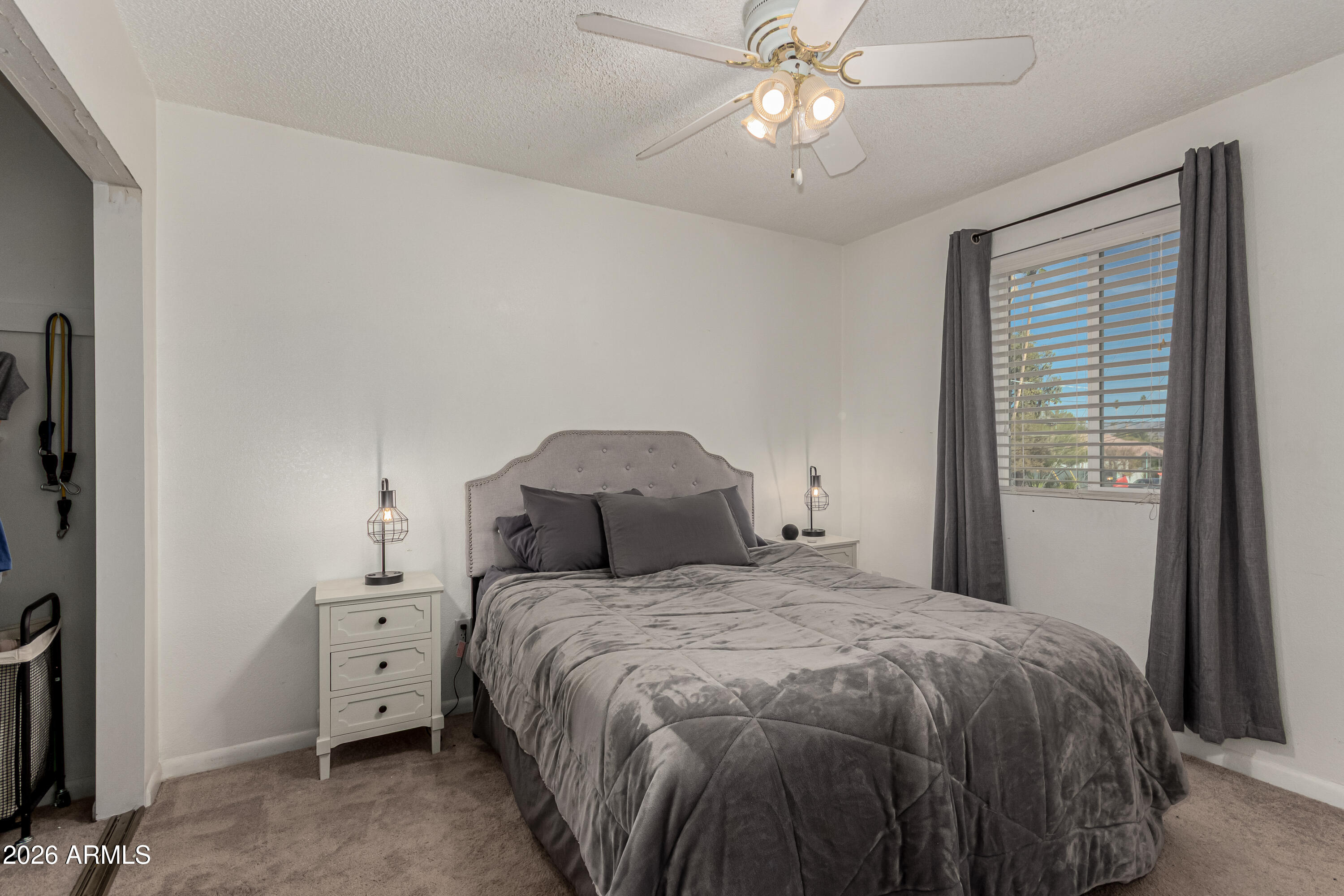 1531 West Colter Street, Unit 1 Phoenix, AZ 85015 - Photo 15 of 32 a bedroom with a large bed and a chandelier