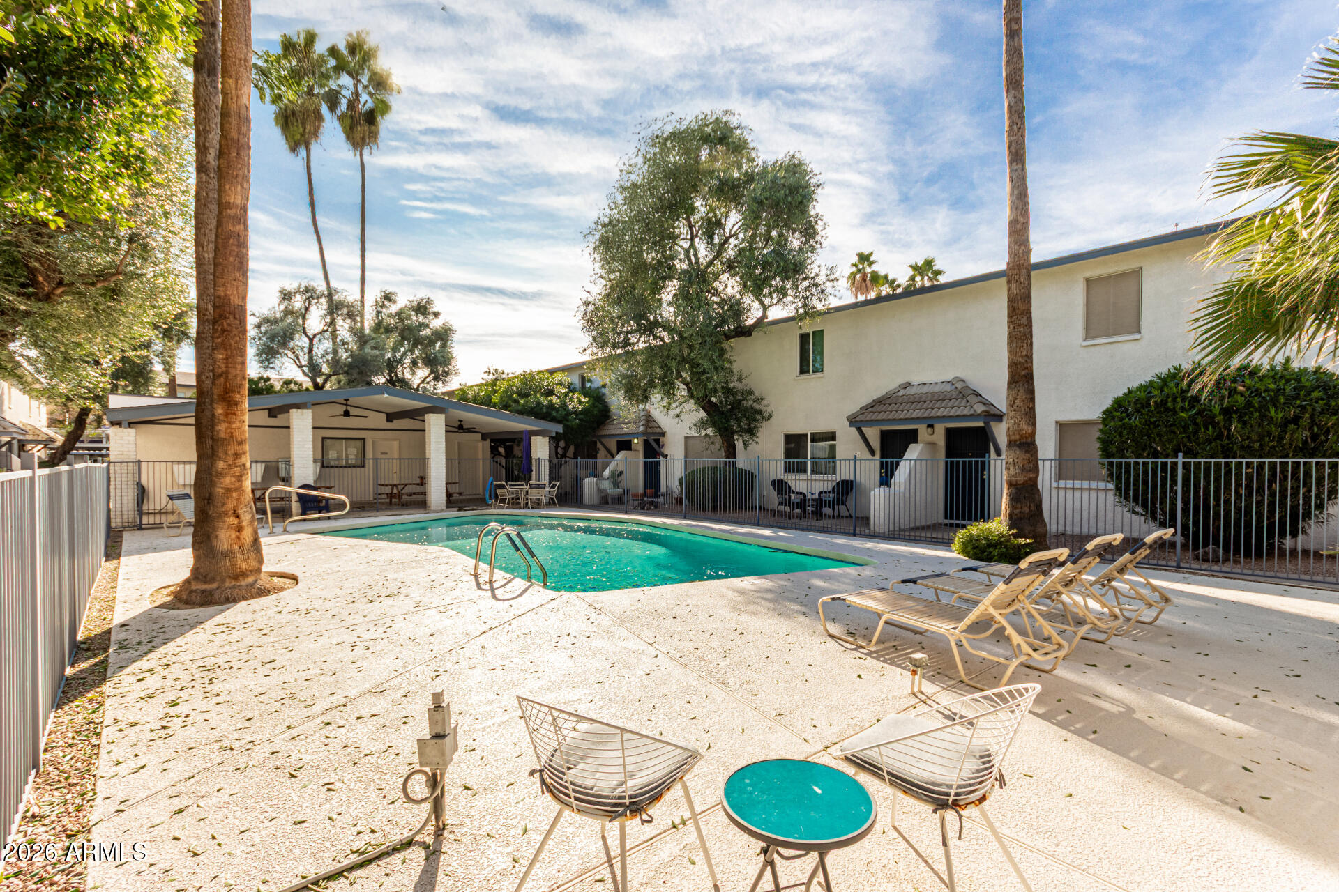 1531 West Colter Street, Unit 1 Phoenix, AZ 85015 - Photo 30 of 32 a view of a patio with table and chairs potted plants with wooden fence