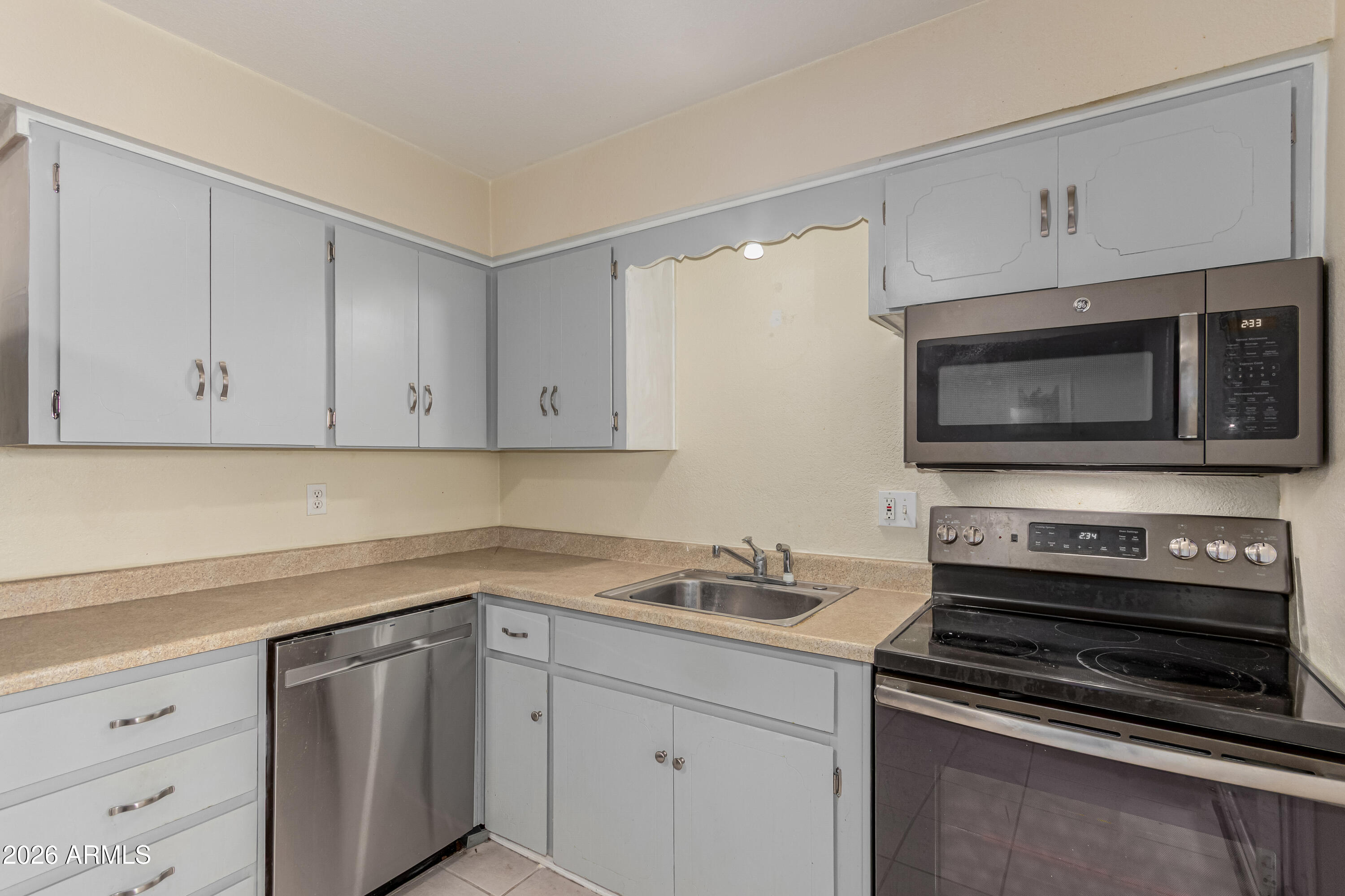 1531 West Colter Street, Unit 1 Phoenix, AZ 85015 - Photo 9 of 32 a kitchen with appliances a sink and cabinets