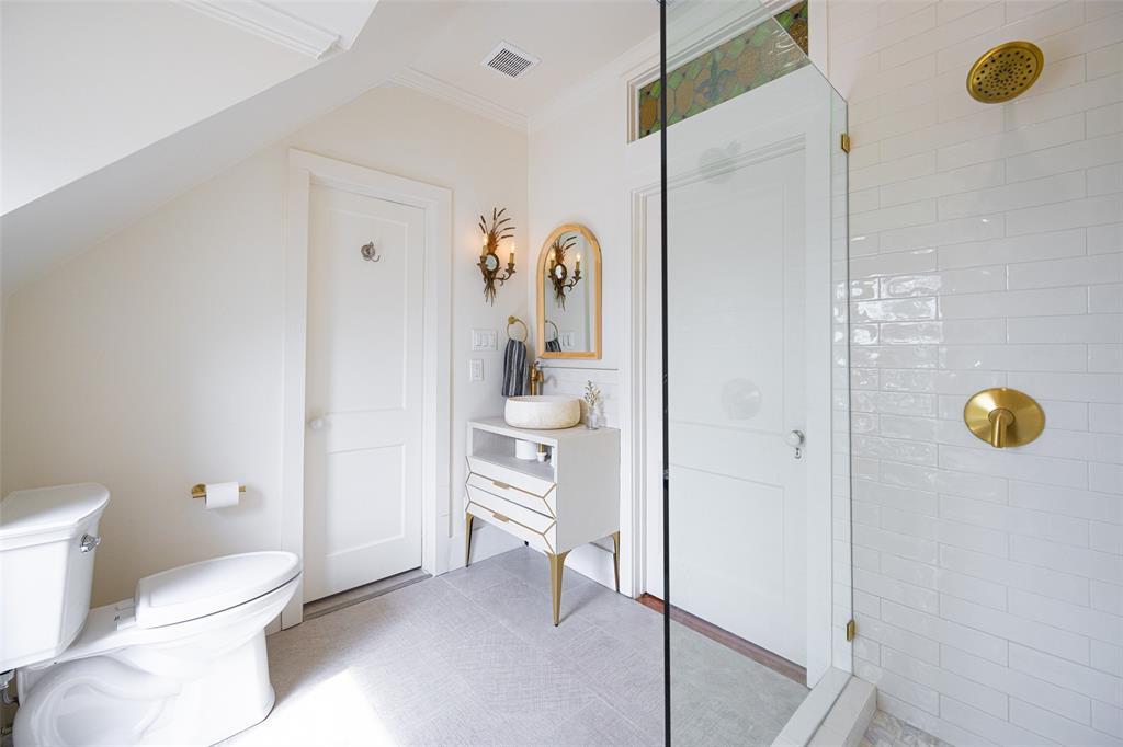 1502 West Virginia Street McKinney, TX 75069 - Photo 29 of 40 a bathroom with a toilet a sink and shower