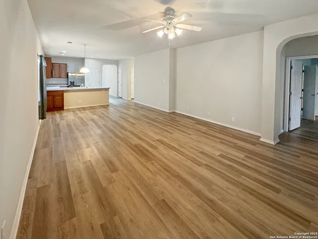 a view of a kitchen with wooden floor and a kitchen space