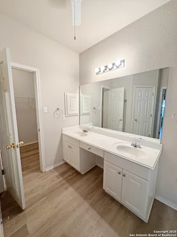 a large bathroom with a double vanity sink a large mirror and a shower