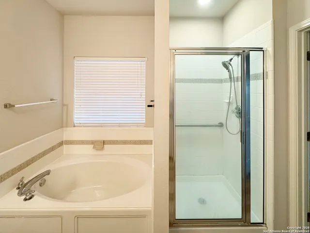 a bathroom with a bathtub and a shower