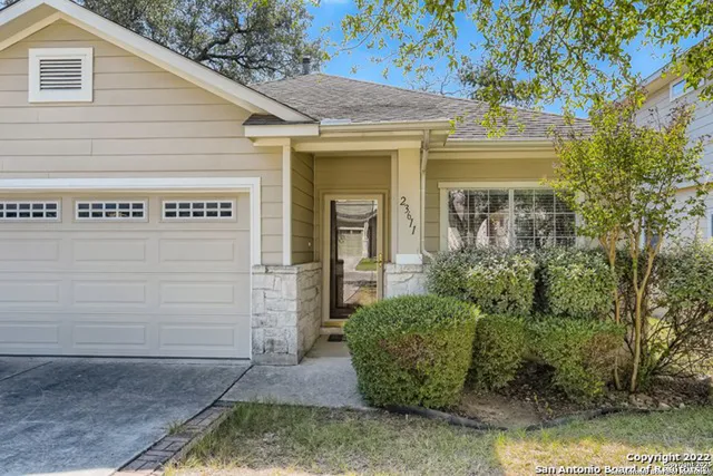 a view of a house with potted plants