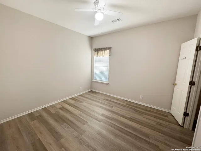 a view of a house with a big yard and large tree