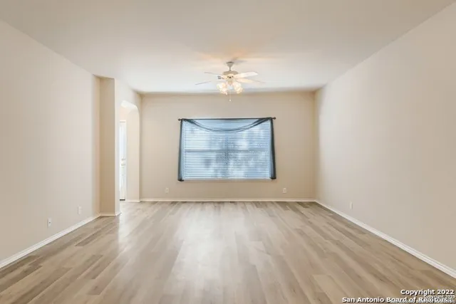 a view of a room with wooden floor chandelier and window