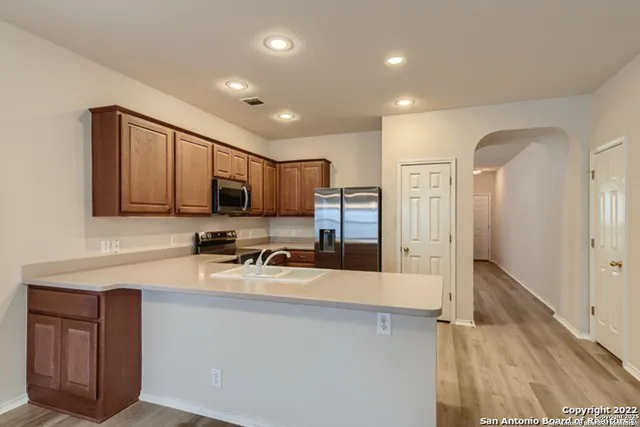 a kitchen with a refrigerator stove and microwave