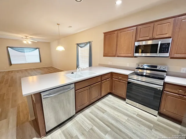 a kitchen with stainless steel appliances granite countertop a sink stove and microwave