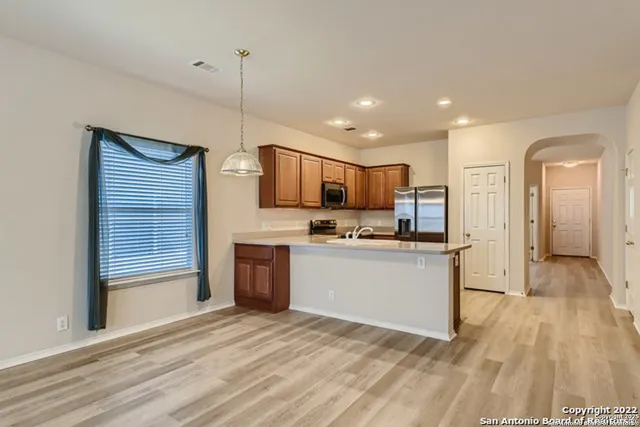 a view of wooden floor and windows in a room