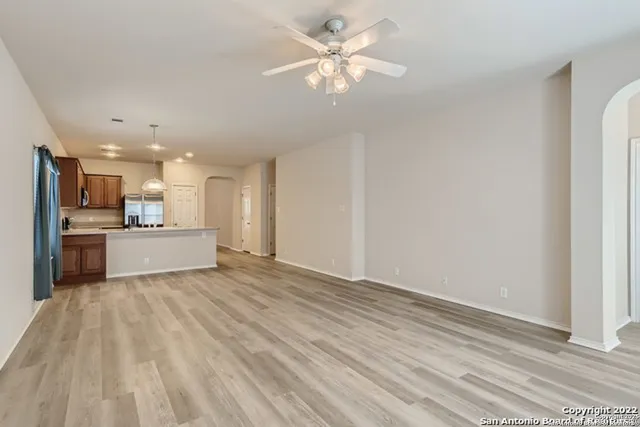 a view of a kitchen with a sink and a refrigerator