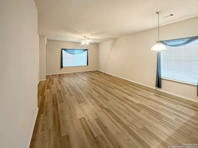 a view of an empty room and wooden floor