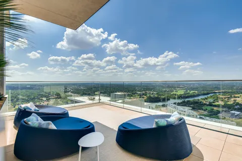 a view of a balcony with chairs