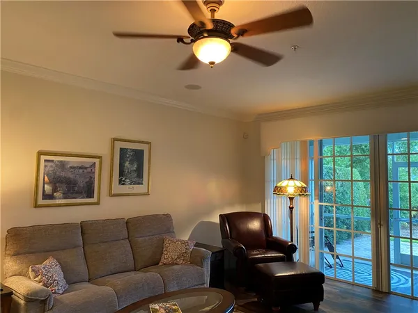 a living room with furniture and a floor to ceiling window