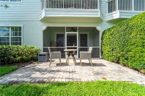 a garden with a bench in front of the house