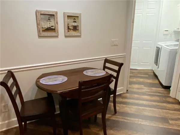 a view of a dining room with furniture and wooden floor