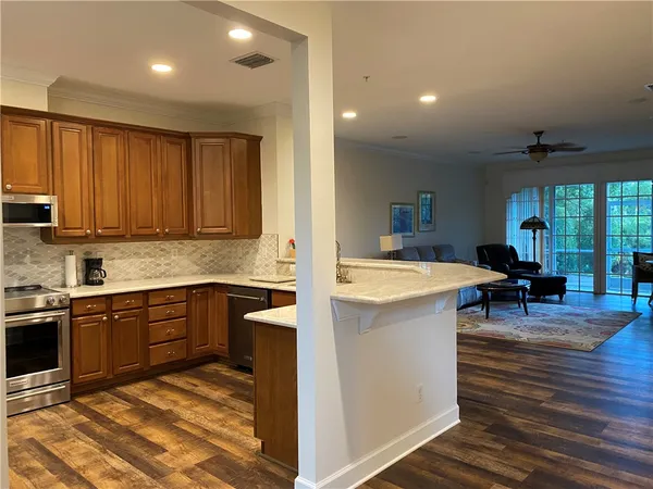 a large kitchen with kitchen island a sink stainless steel appliances and cabinets