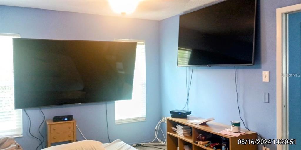 11543 Orleans Lane, Unit 11543 Port Richey, FL 34668 - Photo 11 of 13 a living room with a flat screen tv and a window