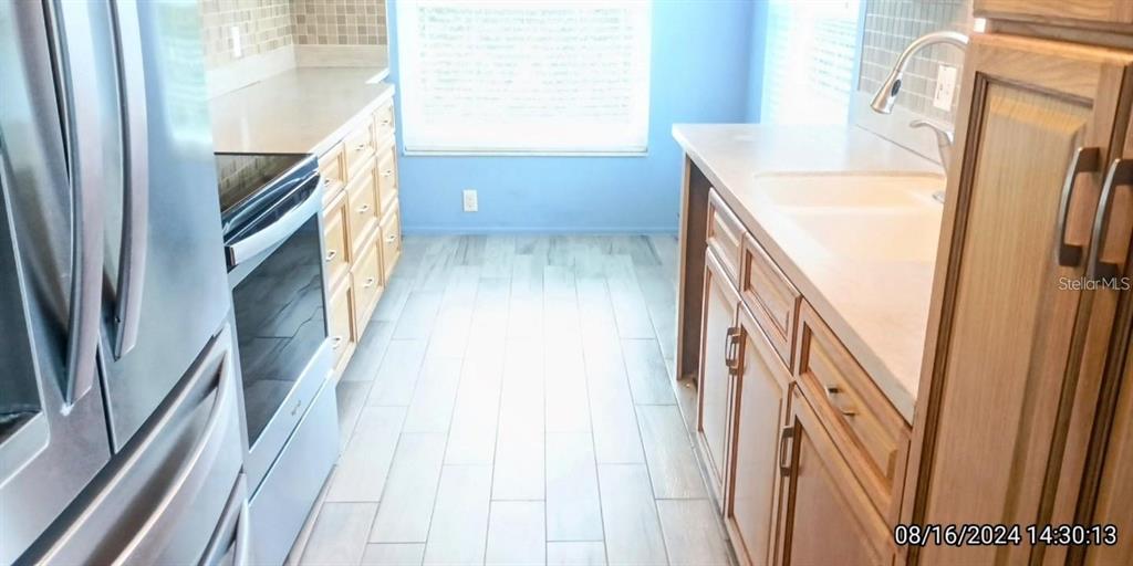 11543 Orleans Lane, Unit 11543 Port Richey, FL 34668 - Photo 2 of 13 a view of an entryway with furniture and a window