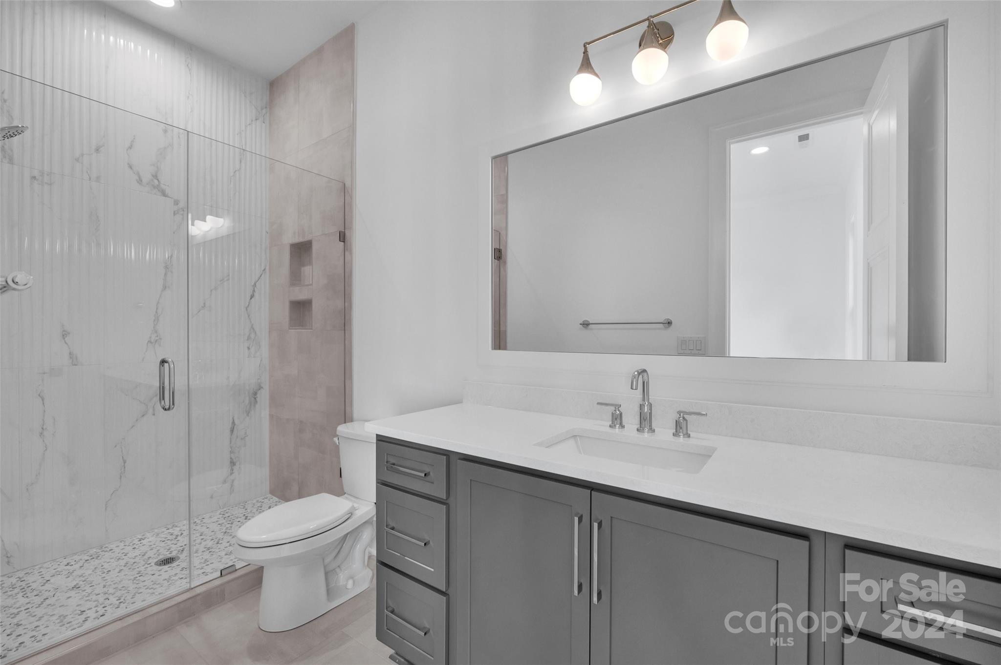 3500 Barclay Downs Drive Charlotte, NC 28209 - Photo 39 of 48 a bathroom with a sink a toilet and shower