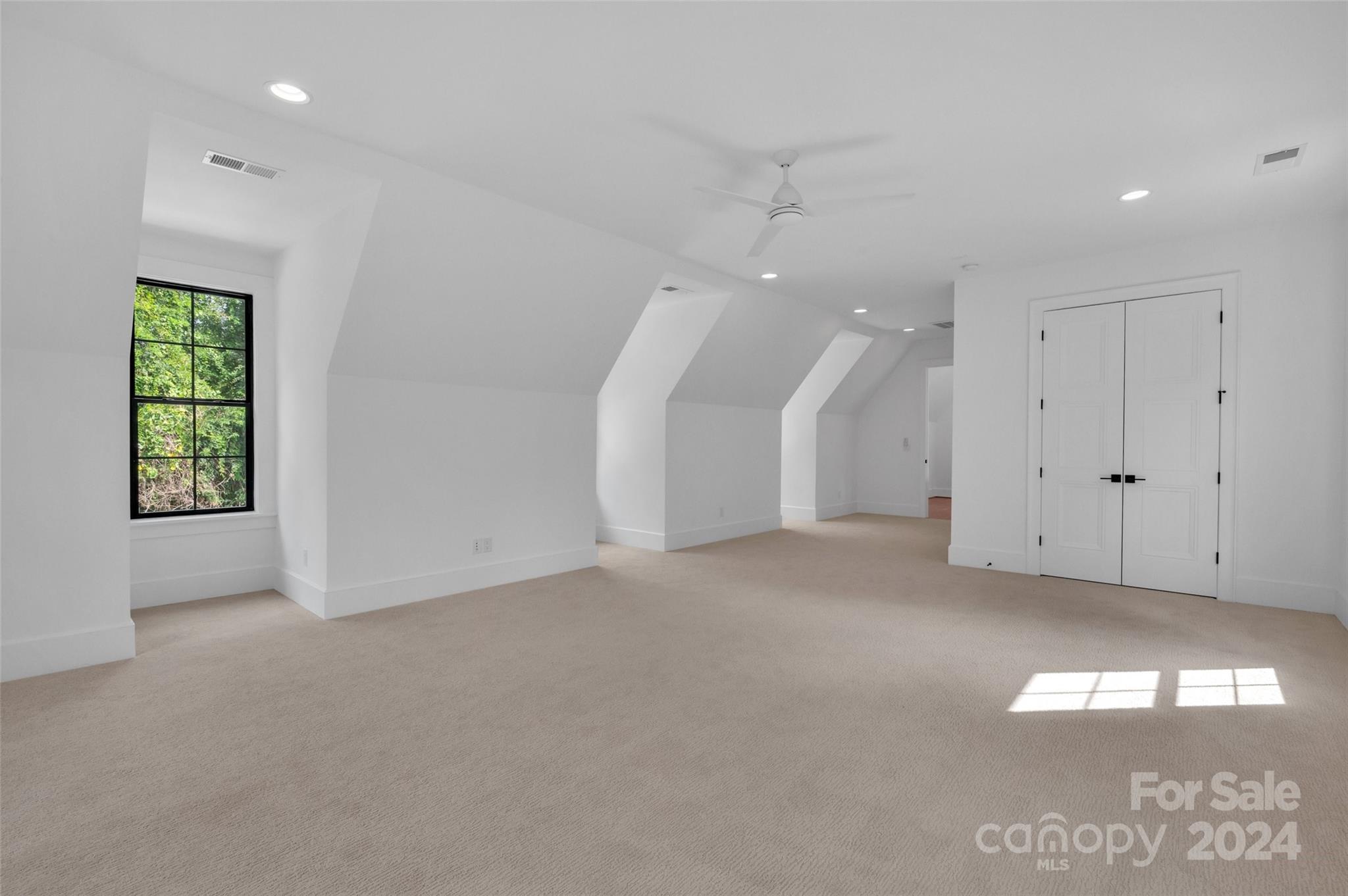 3500 Barclay Downs Drive Charlotte, NC 28209 - Photo 42 of 48 an empty room with a window and ceiling fan