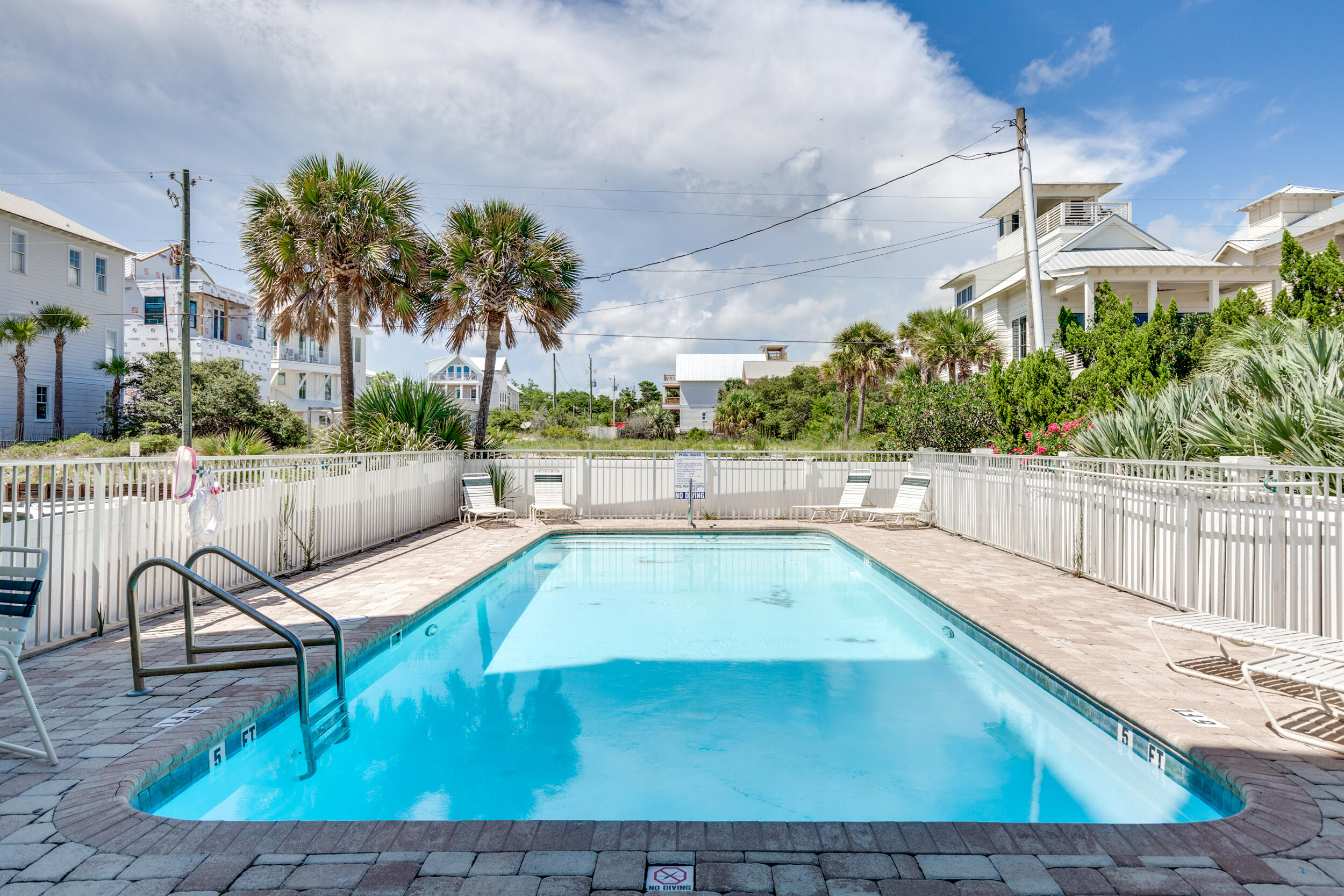 561 Eastern Lake Road, Unit 202 Santa Rosa Beach, FL 32459 - Photo 24 of 32 a view of a swimming pool with a lounge chair