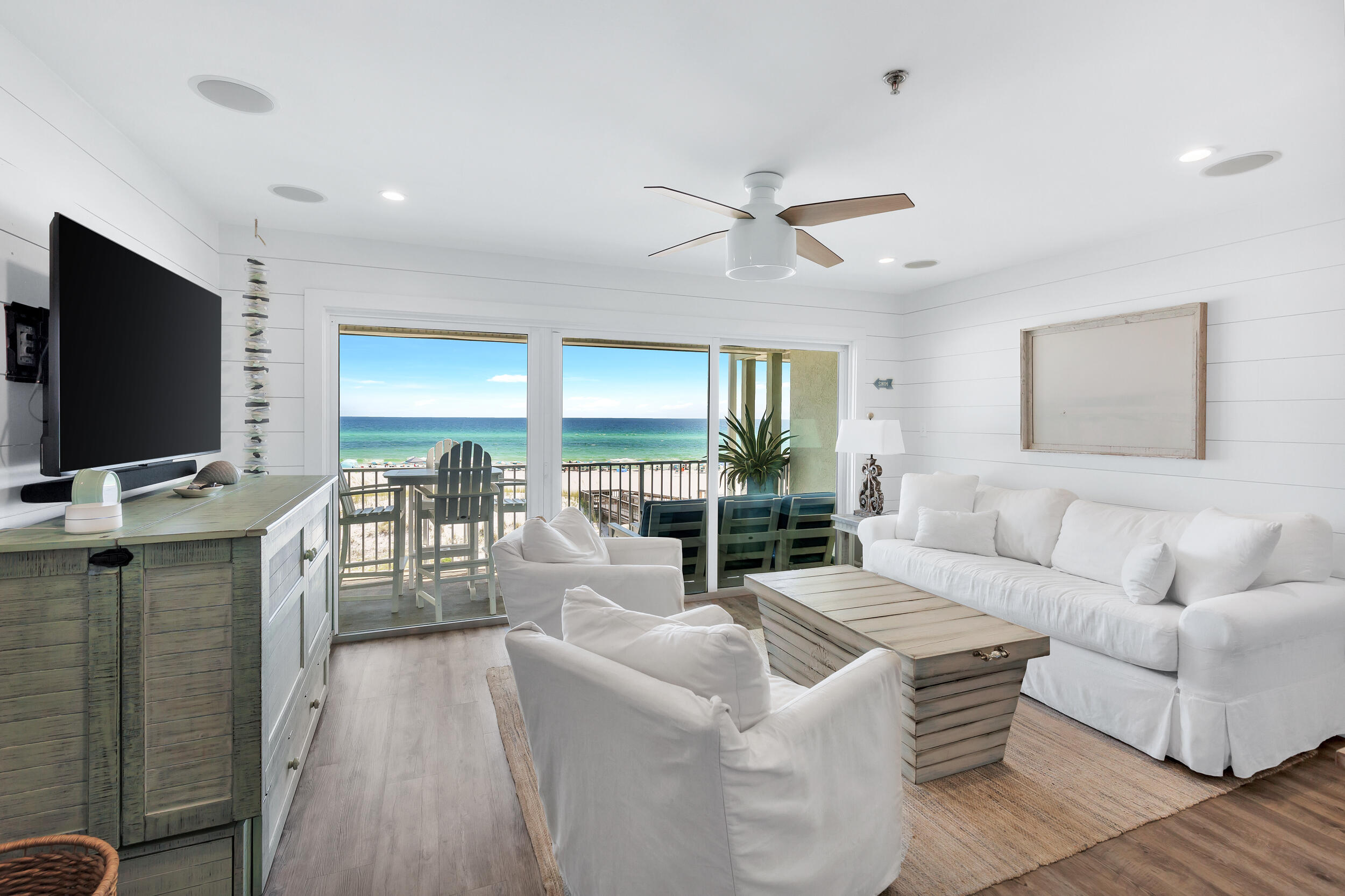 561 Eastern Lake Road, Unit 202 Santa Rosa Beach, FL 32459 - Photo 4 of 32 a living room with furniture a ceiling fan and a flat screen tv