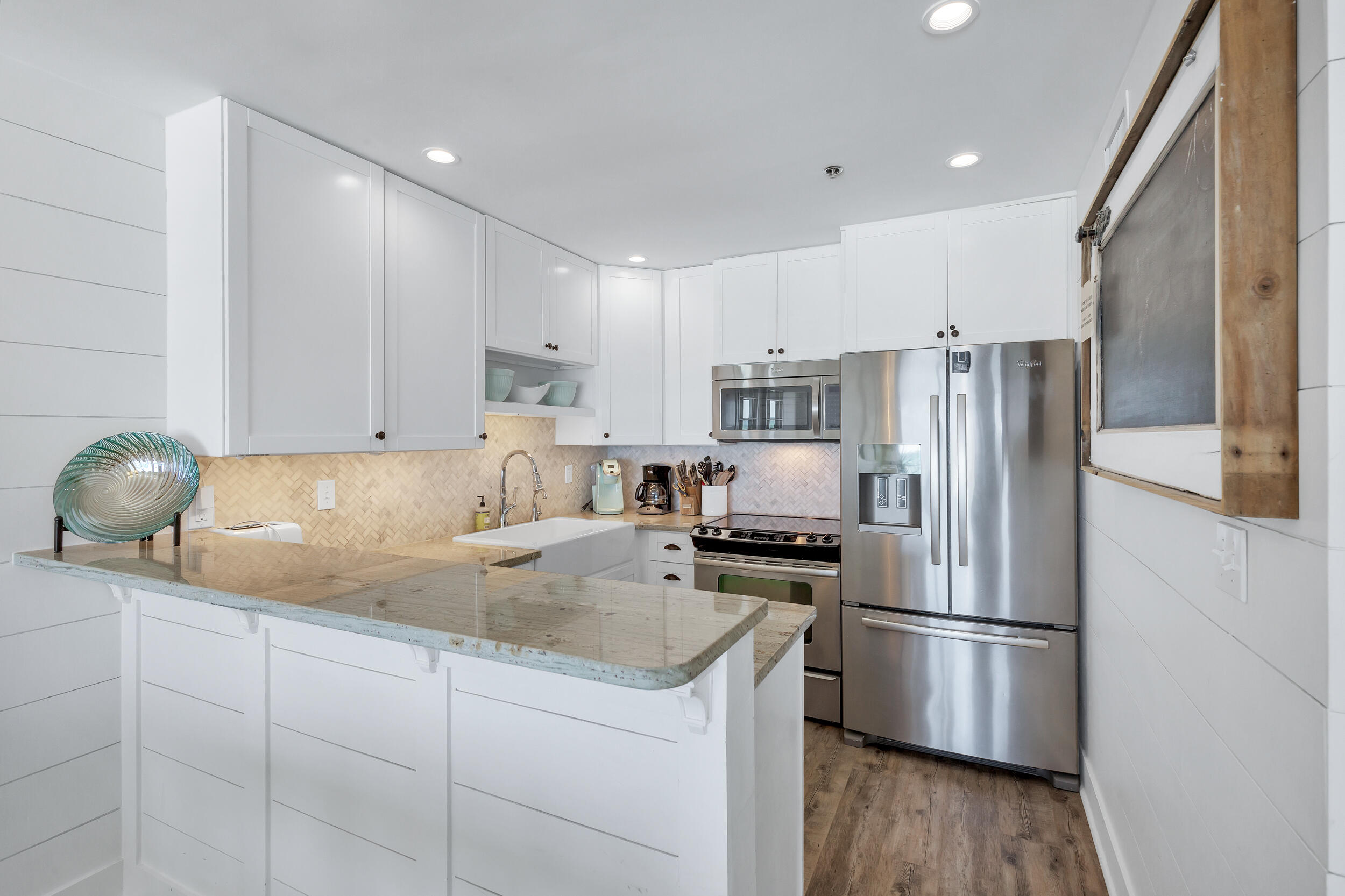 561 Eastern Lake Road, Unit 202 Santa Rosa Beach, FL 32459 - Photo 9 of 32 a kitchen with a refrigerator a stove a sink and cabinets