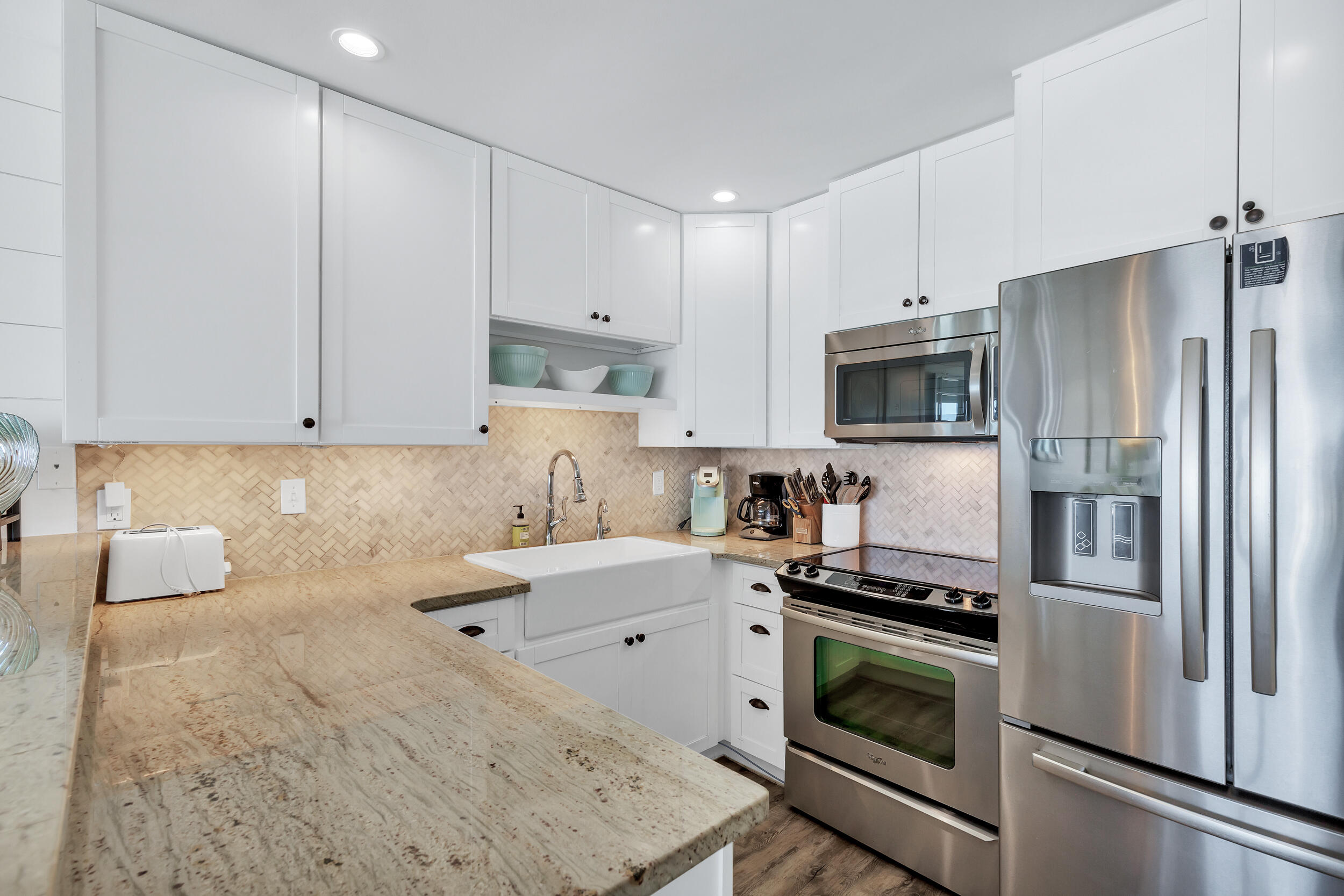 561 Eastern Lake Road, Unit 202 Santa Rosa Beach, FL 32459 - Photo 10 of 32 a kitchen with granite countertop a sink stainless steel appliances and white cabinets