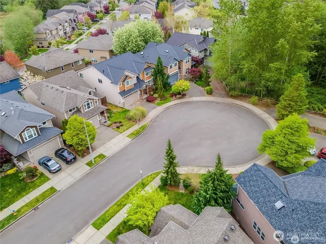an aerial view of a house with a yard and a outdoor seating