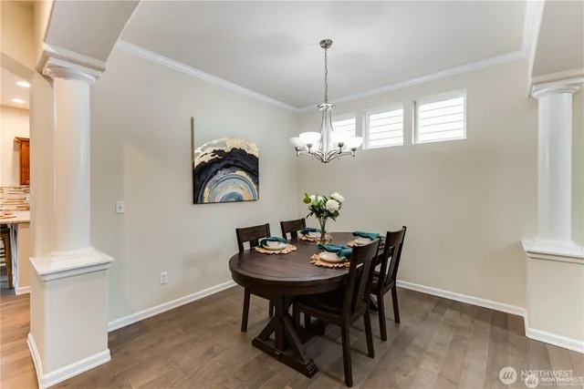 a view of a dining room with furniture and chandelier