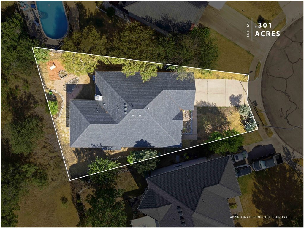Mature trees frame the property boundaries in this overhead view.