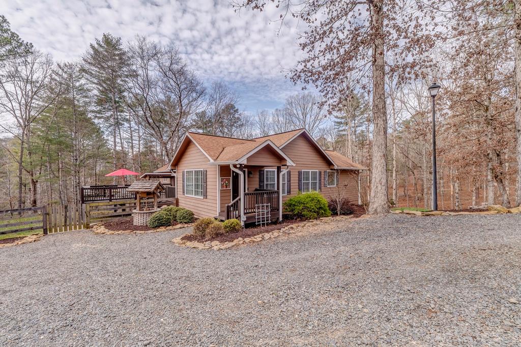 382 Adventure Trail Ellijay, GA 30536 - Photo 1 of 75 a view of a house with large trees and cars parked in front of it