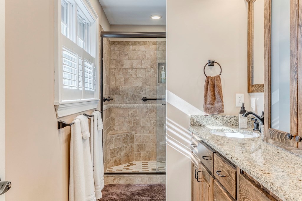 382 Adventure Trail Ellijay, GA 30536 - Photo 13 of 75 a bathroom with a granite countertop sink and a mirror
